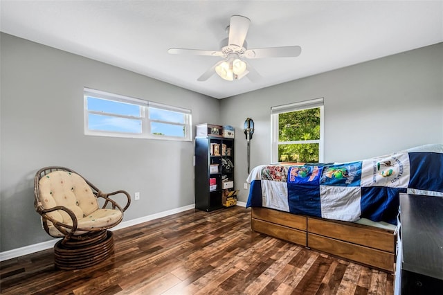 bedroom with ceiling fan and dark hardwood / wood-style flooring