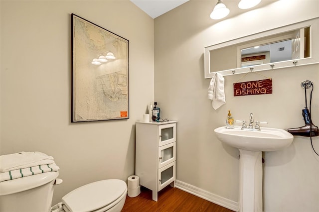 bathroom featuring sink, wood-type flooring, and toilet