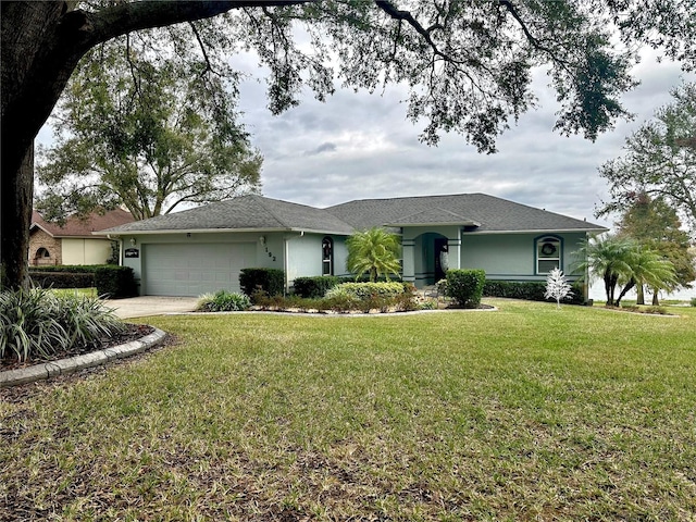 ranch-style home featuring a garage and a front lawn