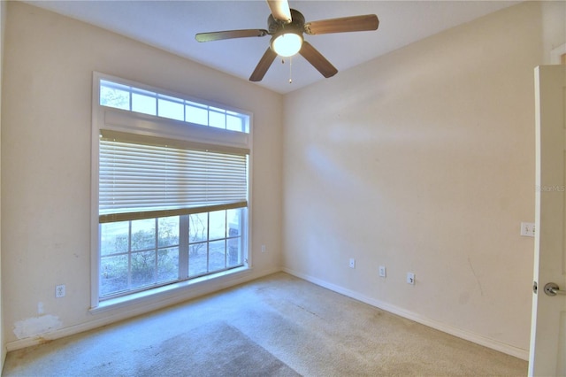 carpeted empty room featuring ceiling fan