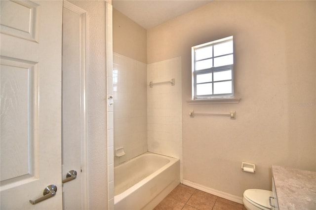 full bathroom with tile patterned flooring, vanity, tiled shower / bath combo, and toilet