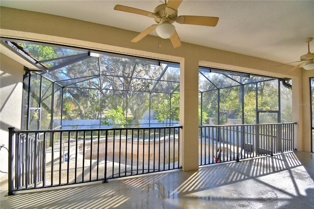 unfurnished sunroom featuring ceiling fan