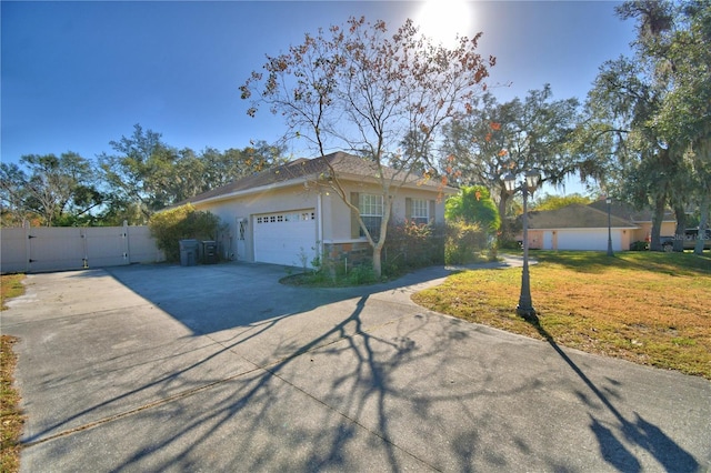 single story home with a garage and a front yard