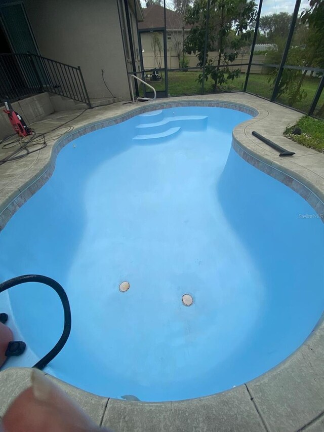 outdoor pool featuring a patio and a lanai