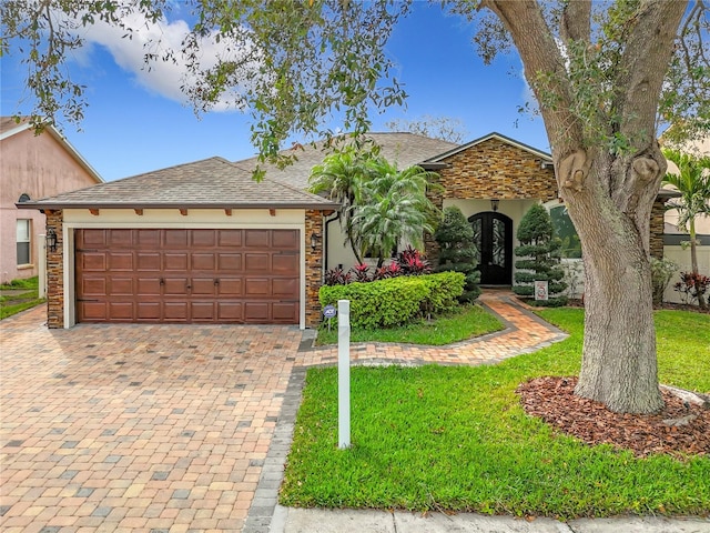 view of front of home featuring a garage and a front lawn