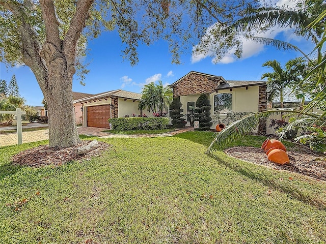 mediterranean / spanish-style house with a garage and a front lawn