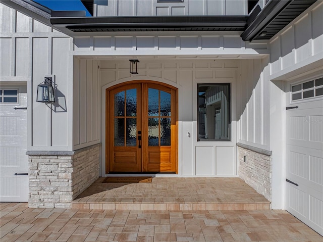2728 Sunrise Landing Ln, Lakeland, FL 33812 - property entrance featuring board and batten siding, french doors, and stone siding