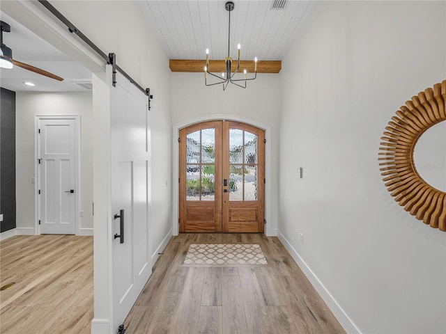 2728 Sunrise Landing Ln, Lakeland, FL 33812 - entrance foyer featuring light wood-style floors, a barn door, recessed lighting, ceiling fan, and a chandelier