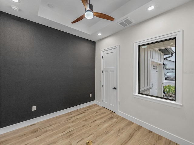 2728 Sunrise Landing Ln, Lakeland, FL 33812 - empty room featuring light wood finished floors, ceiling fan, baseboards, recessed lighting, and a raised ceiling
