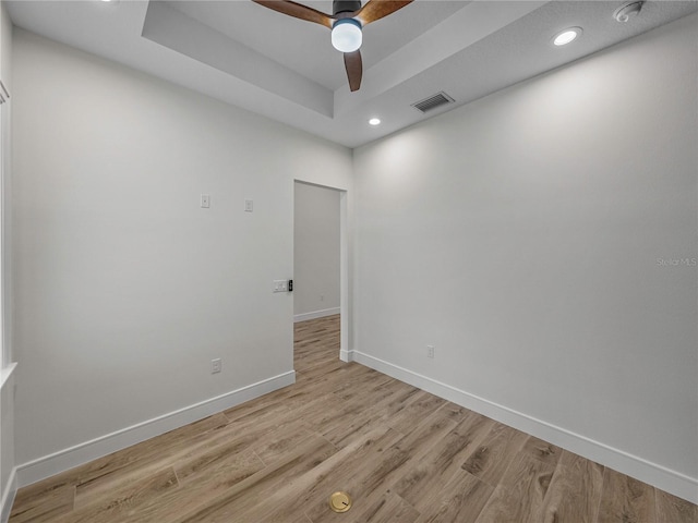 2728 Sunrise Landing Ln, Lakeland, FL 33812 - empty room with baseboards, recessed lighting, light wood-style floors, ceiling fan, and a tray ceiling
