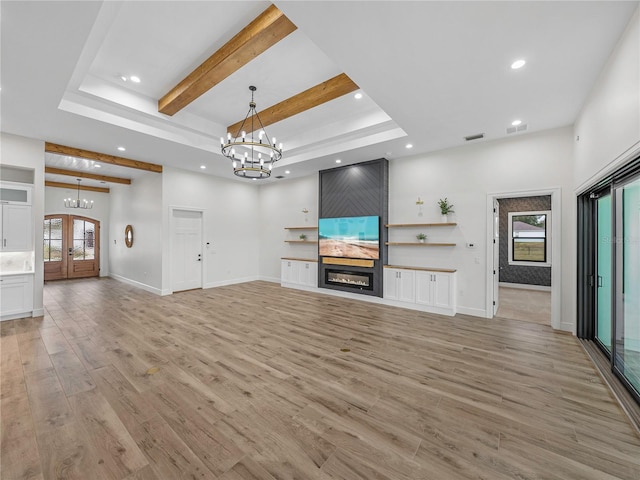 2728 Sunrise Landing Ln, Lakeland, FL 33812 - unfurnished living room featuring a chandelier, recessed lighting, beamed ceiling, a large fireplace, and light wood finished floors