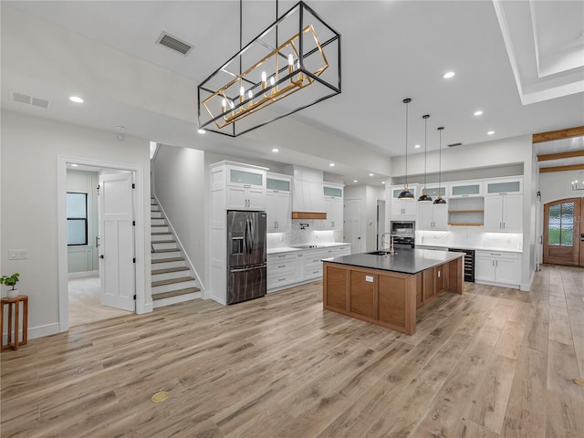 2728 Sunrise Landing Ln, Lakeland, FL 33812 - kitchen with appliances with stainless steel finishes, a sink, light wood finished floors, recessed lighting, and a center island with sink