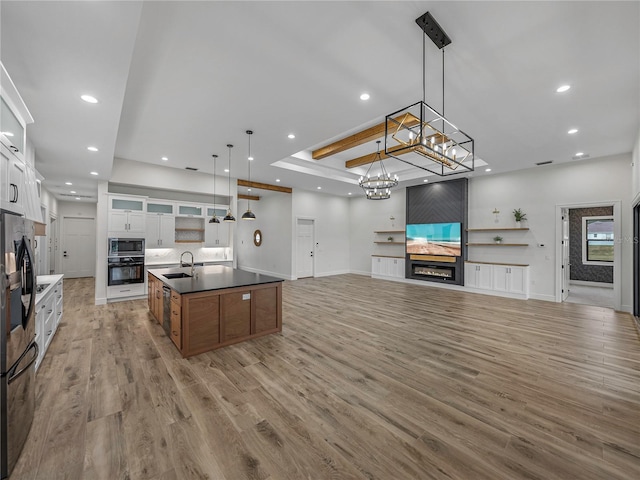 2728 Sunrise Landing Ln, Lakeland, FL 33812 - kitchen featuring black oven, stainless steel microwave, recessed lighting, open floor plan, and white cabinetry