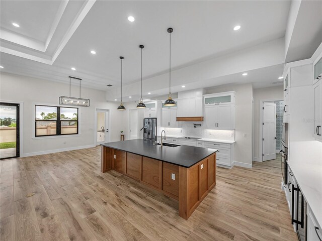 2728 Sunrise Landing Ln, Lakeland, FL 33812 - kitchen featuring stainless steel refrigerator with ice dispenser, a sink, a spacious island, recessed lighting, and black electric cooktop