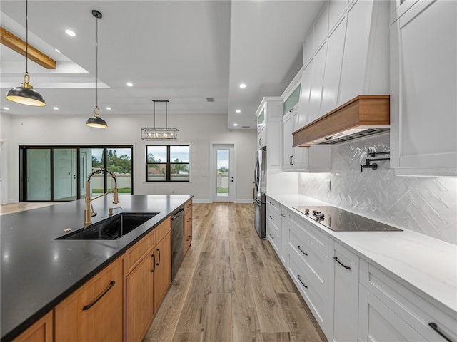 2728 Sunrise Landing Ln, Lakeland, FL 33812 - kitchen featuring a sink, custom exhaust hood, recessed lighting, black electric cooktop, and light wood-style floors