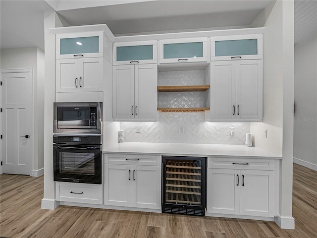 2728 Sunrise Landing Ln, Lakeland, FL 33812 - indoor dry bar with oven, wine cooler, built in microwave, baseboards, and tasteful backsplash