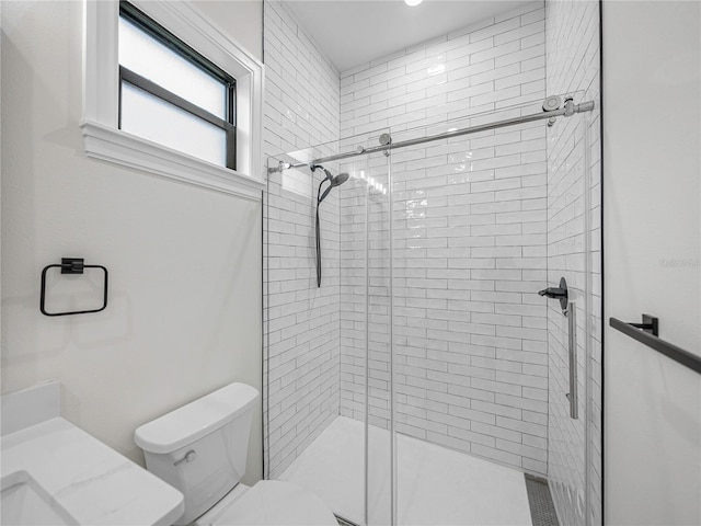 bathroom with an enclosed shower and toilet