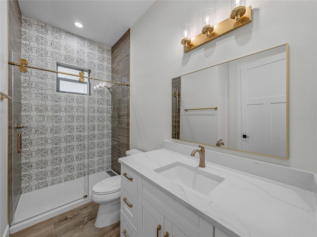 2728 Sunrise Landing Ln, Lakeland, FL 33812 - bathroom with toilet, vanity, a stall shower, wood finished floors, and recessed lighting