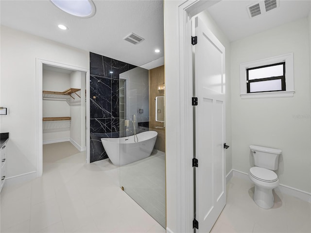 2728 Sunrise Landing Ln, Lakeland, FL 33812 - bathroom with a stall shower, a freestanding tub, a spacious closet, toilet, and vanity