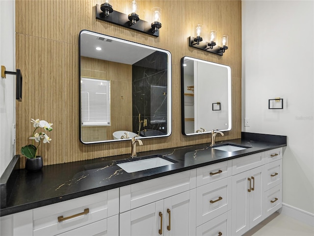 2728 Sunrise Landing Ln, Lakeland, FL 33812 - bathroom featuring double vanity, a shower, and baseboards