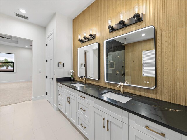 2728 Sunrise Landing Ln, Lakeland, FL 33812 - full bathroom with double vanity, a shower stall, and baseboards