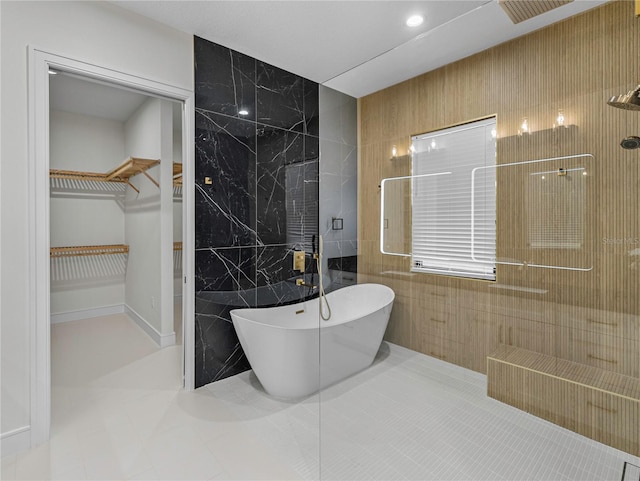 bathroom with tile patterned flooring, independent shower and bath, and tile walls