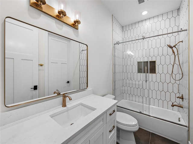 2728 Sunrise Landing Ln, Lakeland, FL 33812 - full bathroom with vanity, toilet, combined bath / shower with glass door, tile patterned floors, and recessed lighting