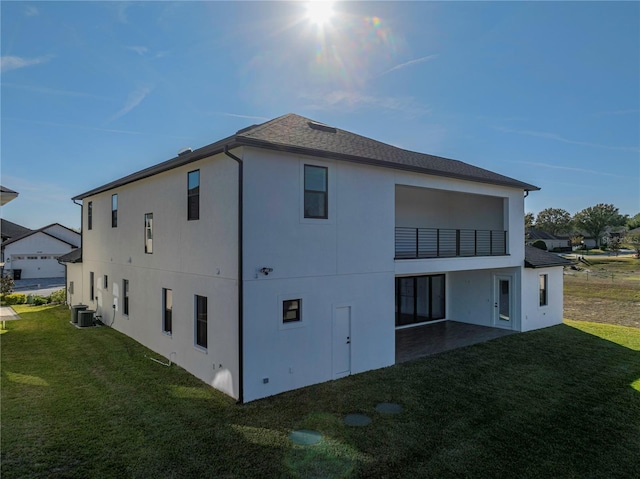 2728 Sunrise Landing Ln, Lakeland, FL 33812 - view of side of property with a balcony, stucco siding, a lawn, and a patio area