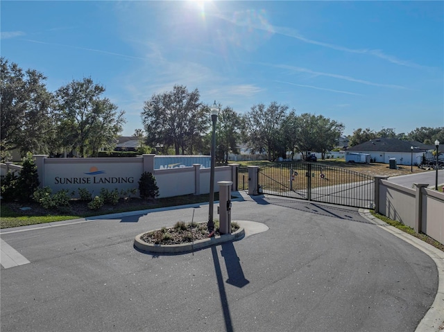 2728 Sunrise Landing Ln, Lakeland, FL 33812 - view of asphalt road featuring street lighting, a gate, a gated entry, and curbs