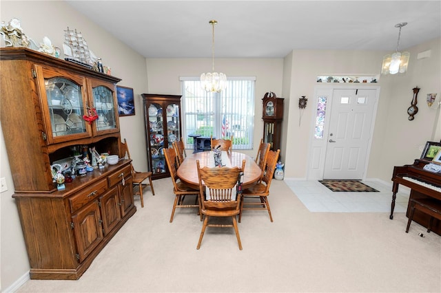 carpeted dining area with a notable chandelier