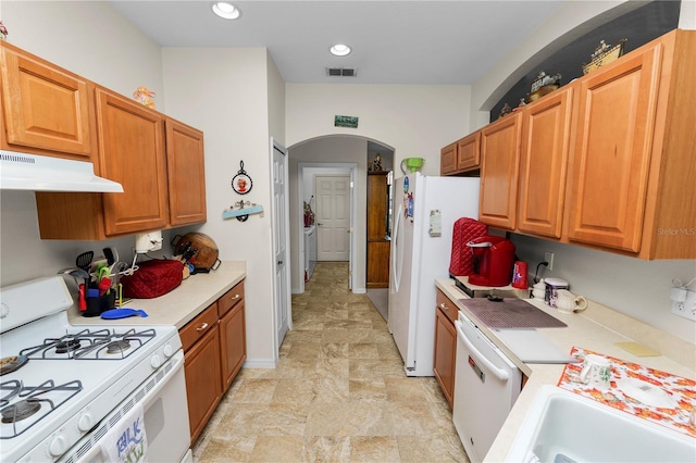 kitchen with washing machine and dryer and white appliances