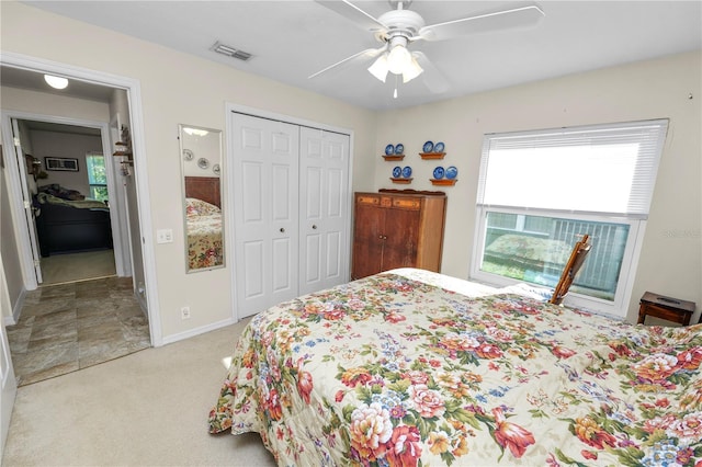 bedroom with light carpet, a closet, and ceiling fan