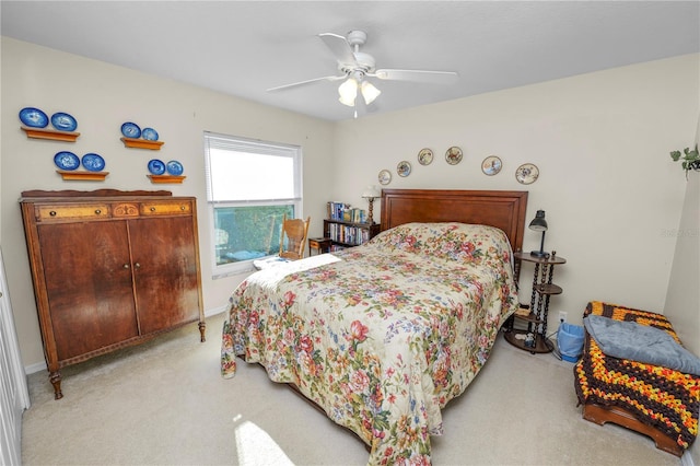 bedroom with ceiling fan and light colored carpet