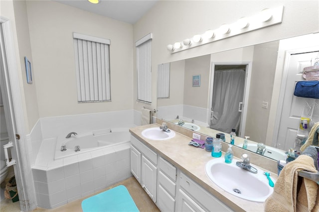 bathroom with vanity, a relaxing tiled tub, and toilet