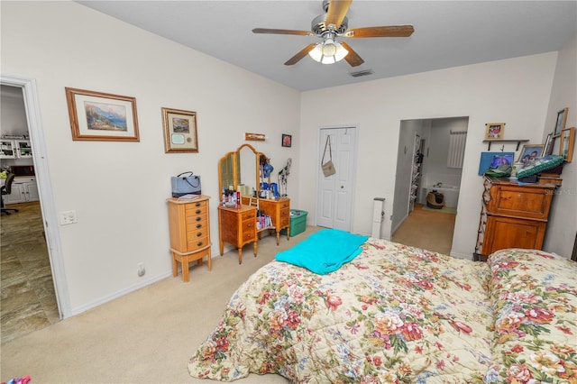 bedroom featuring connected bathroom, ceiling fan, and light colored carpet