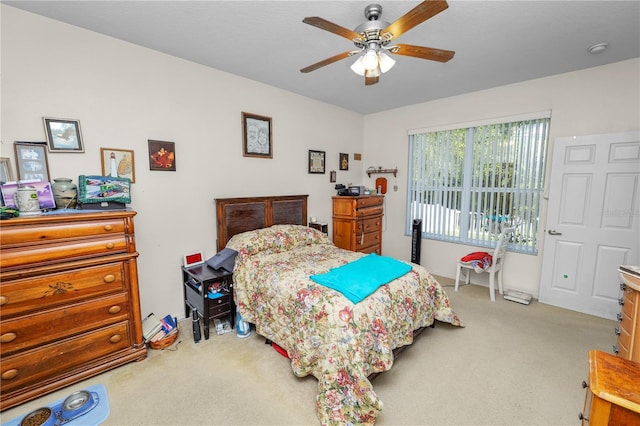 bedroom featuring ceiling fan and light carpet