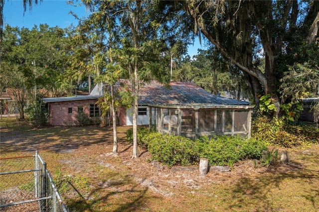 back of property featuring a sunroom