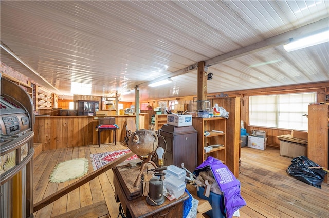 miscellaneous room featuring wood walls and light hardwood / wood-style floors