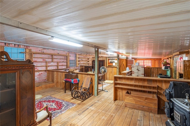 interior space with wood walls, light hardwood / wood-style floors, and white refrigerator