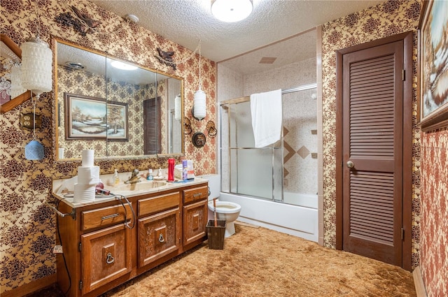 full bathroom featuring toilet, vanity, a textured ceiling, and combined bath / shower with glass door