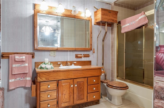 full bathroom with tile patterned floors, vanity, toilet, and combined bath / shower with glass door