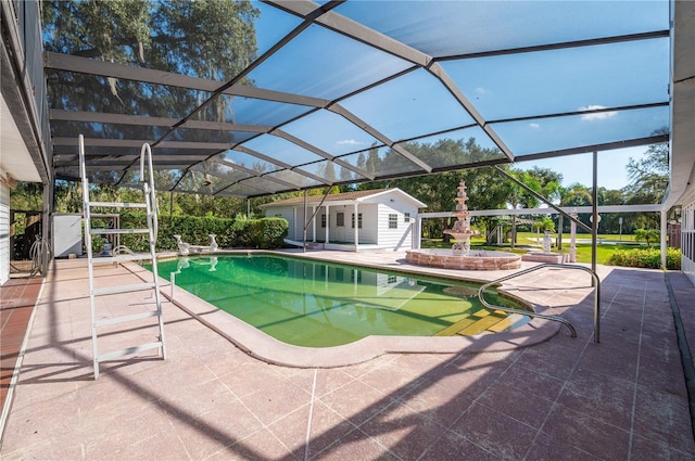 view of swimming pool with a patio, glass enclosure, and an outdoor structure