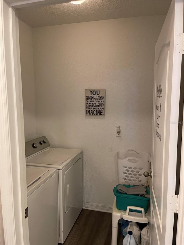 washroom featuring a textured ceiling, washer and dryer, and dark hardwood / wood-style floors