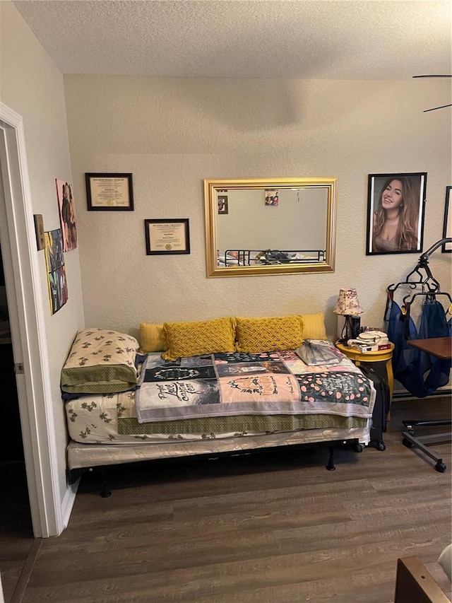 bedroom featuring hardwood / wood-style floors and a textured ceiling