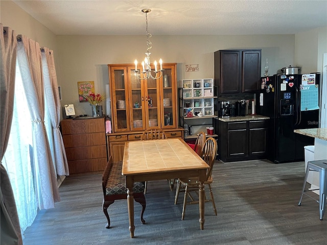 dining room featuring dark wood-style flooring and a notable chandelier