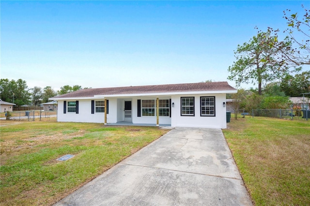 ranch-style house with covered porch and a front yard