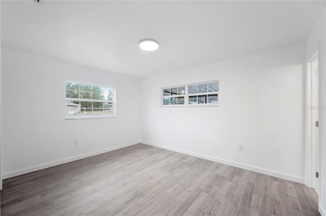 empty room with hardwood / wood-style floors