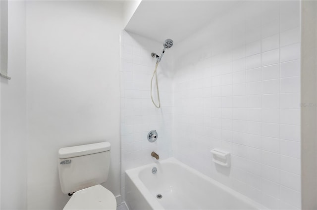 bathroom with tiled shower / bath combo and toilet