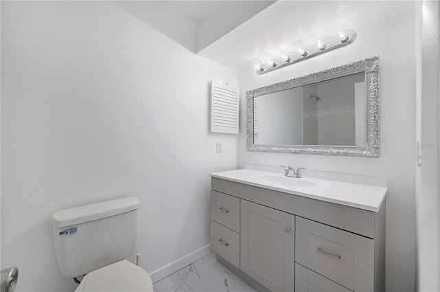 bathroom with vanity, toilet, and walk in shower