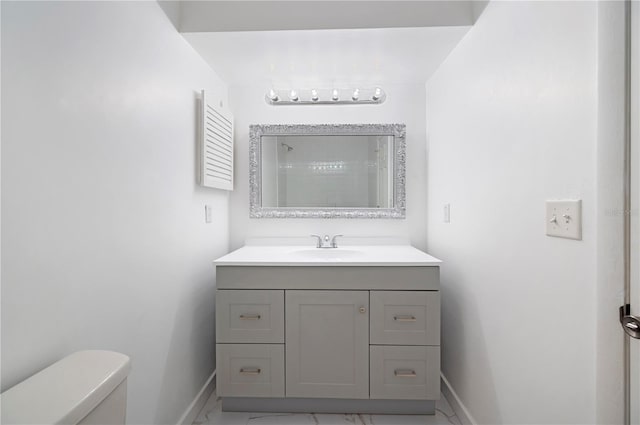 bathroom with vanity, toilet, and walk in shower